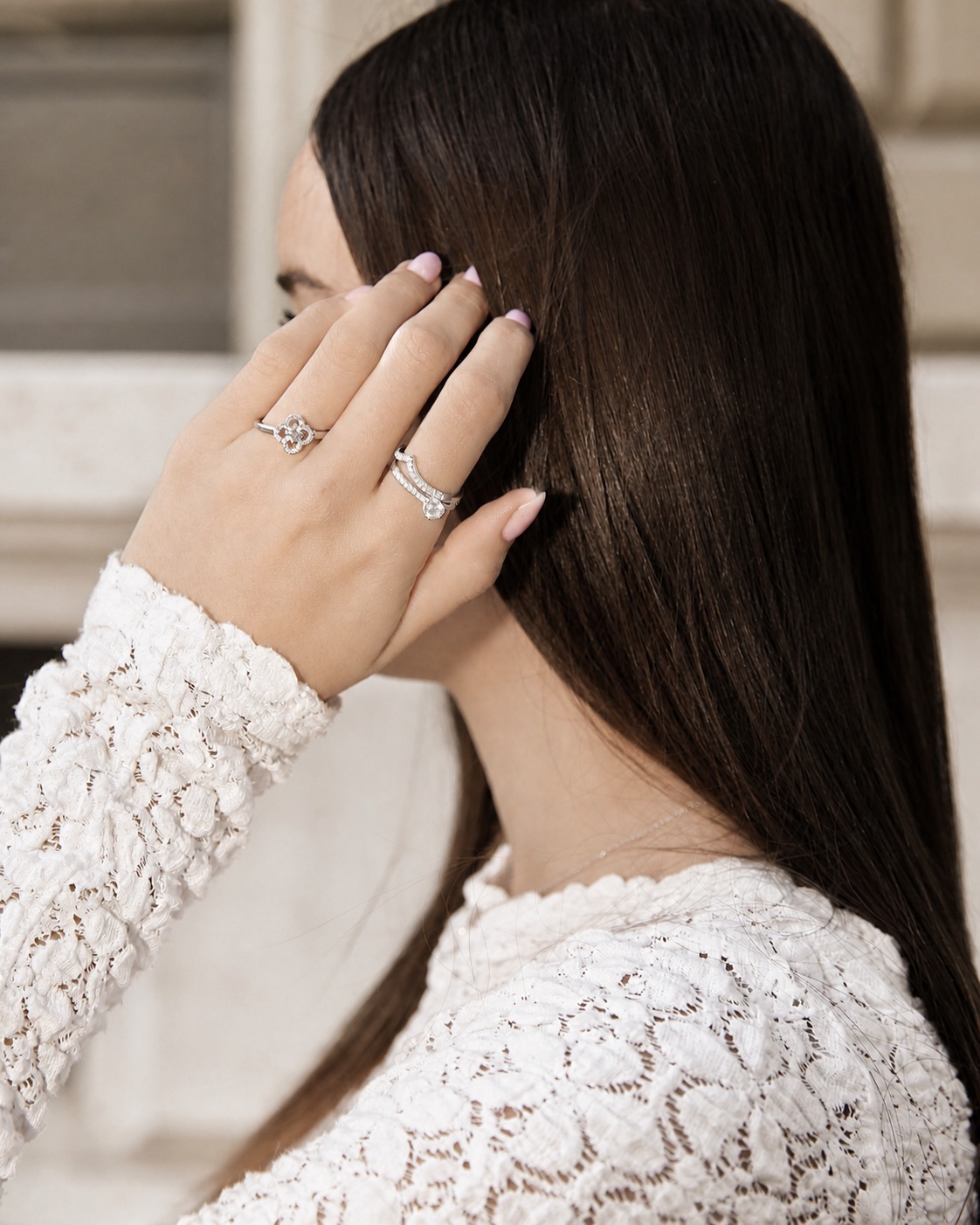 Woman wearing diamond engagement rings in an elegant bridal-inspired portrait